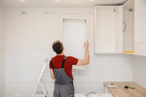 depositphotos_407349822-stock-photo-kitchen-installation-worker-assembling-furniture